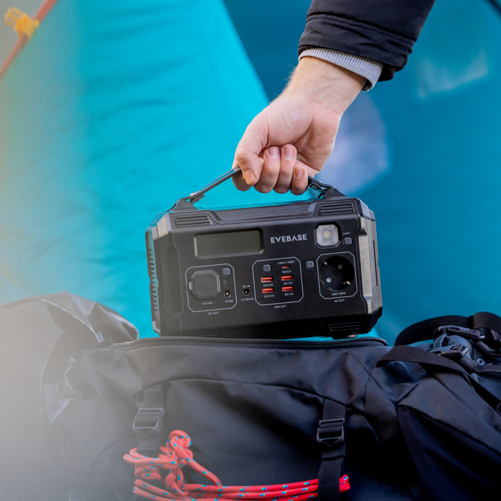Taking the EveBase Move 300 portable power station out of a backpack.